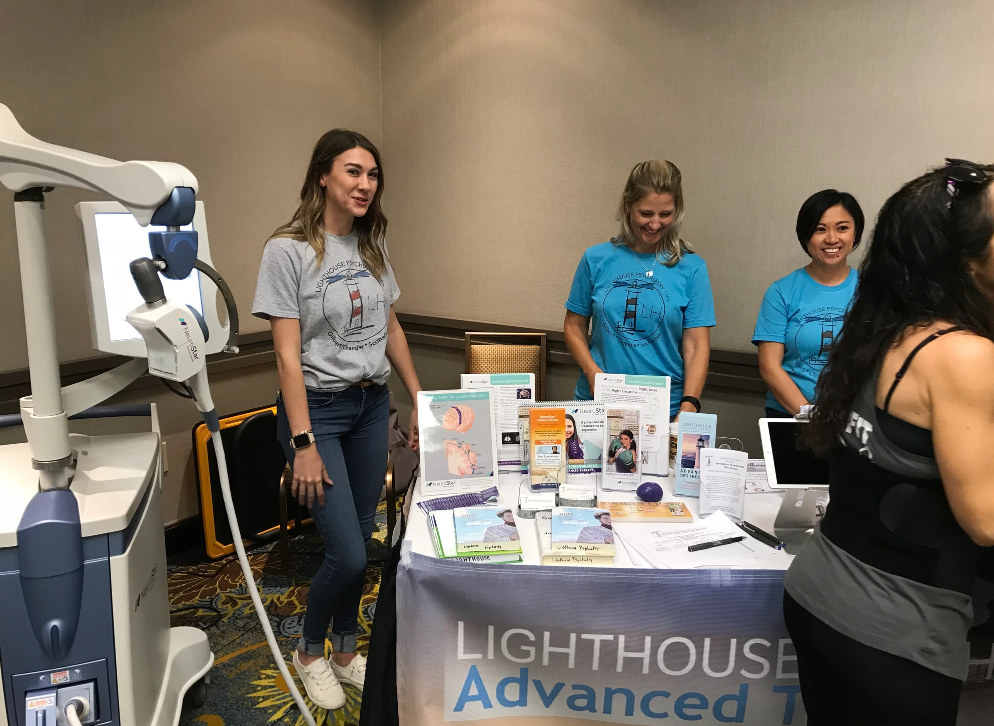 Lighthouse Psychiatry team members at the Mind and Wellness Conference booth.