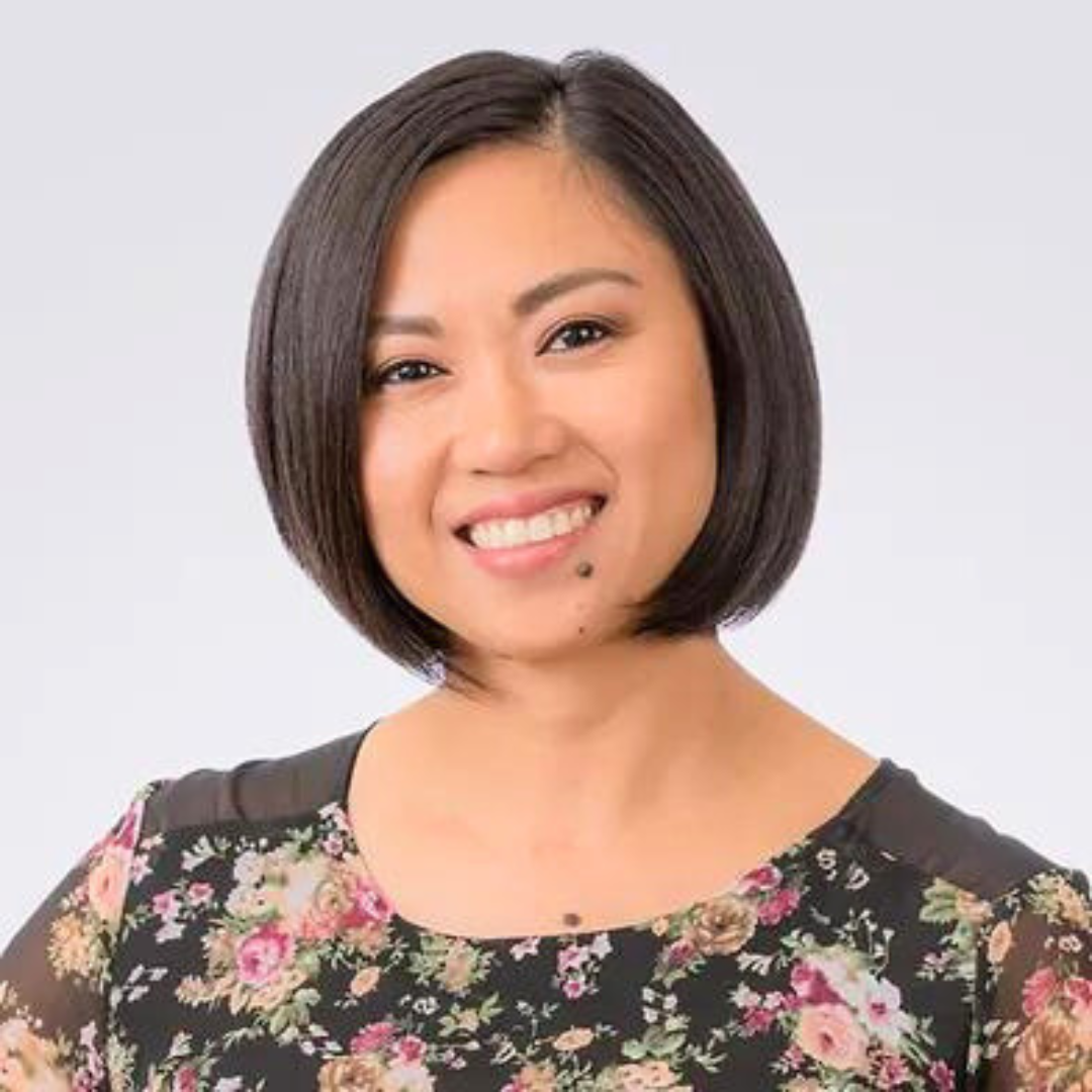 Smiling female therapist with short hair wearing a floral blouse