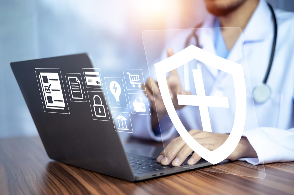 A doctor focused on a laptop, with a shield icon displayed, symbolizing health and security in medical practice.
