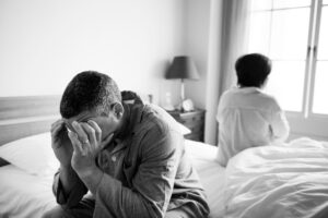 Man seated in the bed undergoing PTSD or post-traumatic stress disorder