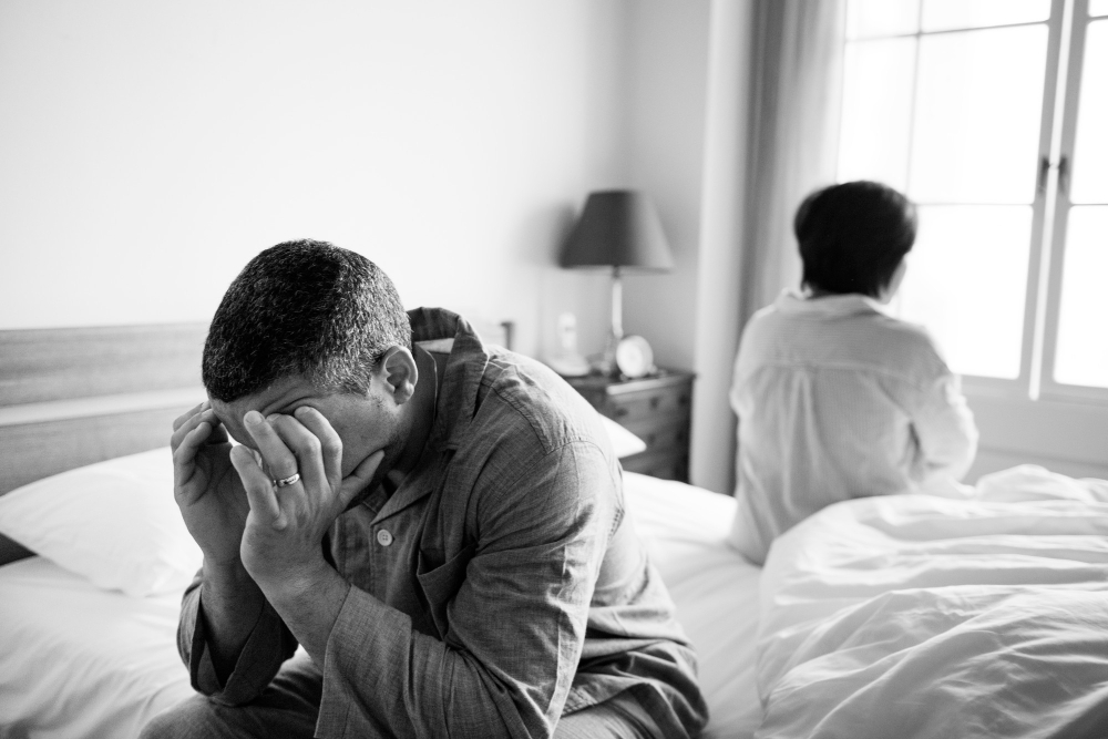 Man seated in the bed undergoing PTSD or post-traumatic stress disorder